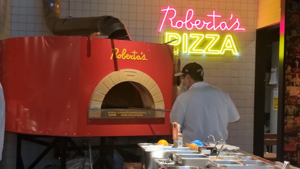 Preparing pizza at Roberta's Pizza restaurant in Singapore