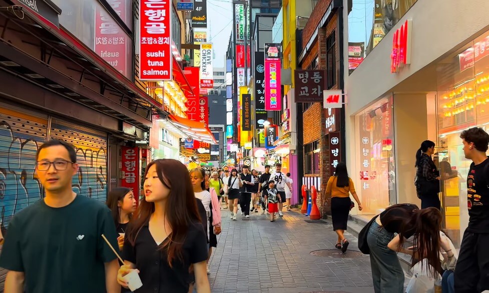 Pedestrians navigate a narrow street in Korea