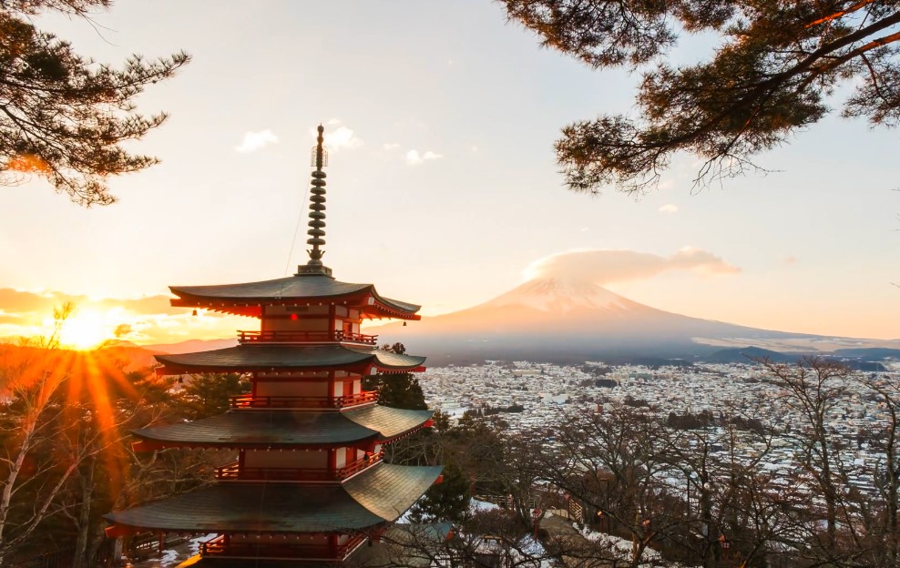 Pagoda stands tall against the backdrop of Mount Fuji, a serene winter sunrise