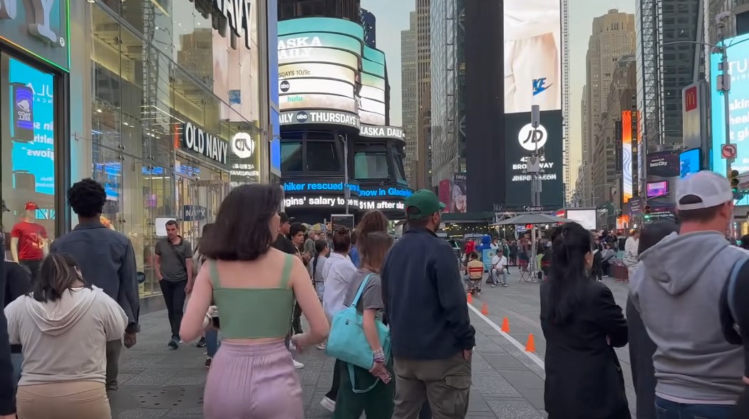 Singaporean girl walking through crowded street in New York