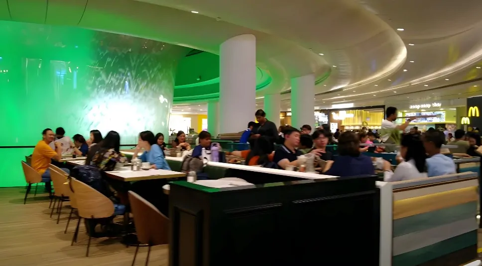 People seating at food restaurant at Changi Airport