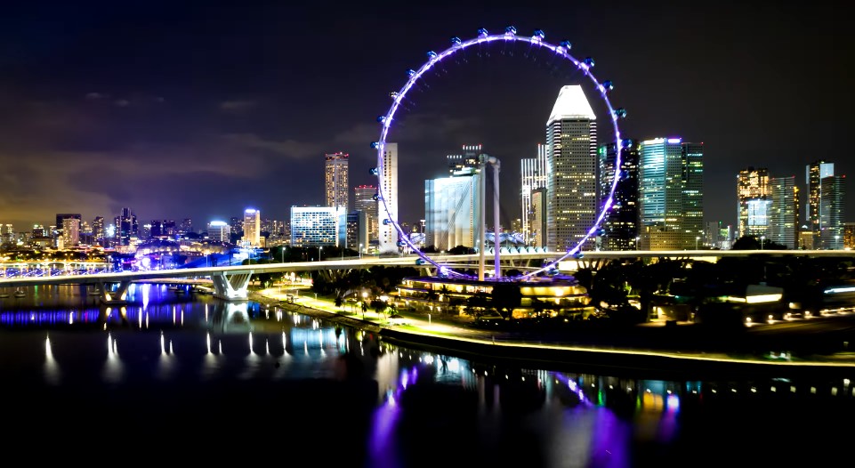 Singapore's skyline at night, illuminated by the dazzling Flyer wheel